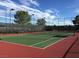 Well-maintained tennis court with red and green surface, ready for a friendly match at 2013 Capestone St, Las Vegas, NV 89134