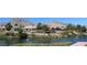 Serene water view showcasing luxury homes with well-manicured landscaping and stunning mountain backdrop at 2013 Capestone St, Las Vegas, NV 89134