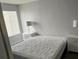 Simple bedroom with a queen bed, two bedside tables, and decorative lamps; a peaceful retreat for relaxation at 2200 S Fort Apache Rd # 2071, Las Vegas, NV 89117
