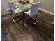 Modern dining area featuring a glass table and stylish chairs set on a wooden floor, perfect for gatherings at 2200 S Fort Apache Rd # 2071, Las Vegas, NV 89117