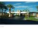 A beautiful gate surrounded by palm trees offers a secure entrance into a private community at 2200 S Fort Apache Rd # 2071, Las Vegas, NV 89117