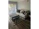 Cozy living room featuring a comfortable couch, stylish ottoman, and elegant rug, perfect for relaxation at 2200 S Fort Apache Rd # 2071, Las Vegas, NV 89117