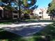 Community sand volleyball court with lush landscaping and mature trees at 2200 S Fort Apache Rd # 2071, Las Vegas, NV 89117