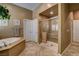 Bathroom featuring a walk-in shower, soaking tub, and dual vanity at 2425 Amatrice St, Henderson, NV 89044
