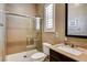 Updated bathroom with tiled shower and glass enclosure at 2425 Amatrice St, Henderson, NV 89044