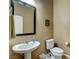 Stylish powder room featuring a pedestal sink and decorative wallpaper at 2425 Amatrice St, Henderson, NV 89044