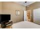 Cozy bedroom featuring neutral walls, TV, and a closet for ample storage at 2425 Amatrice St, Henderson, NV 89044