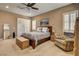 Main bedroom with seating area, plantation shutters, and neutral carpet at 2425 Amatrice St, Henderson, NV 89044