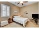 Inviting bedroom with neutral decor, plush carpet, and natural light from shuttered windows at 2425 Amatrice St, Henderson, NV 89044