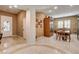 Open-concept dining area features elegant tile flooring, neutral walls, and natural light from shuttered windows at 2425 Amatrice St, Henderson, NV 89044