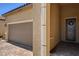 Home exterior showcases a two-car garage and decorative front door at 2425 Amatrice St, Henderson, NV 89044