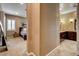 Hallway that leads to a bedroom and a bathroom with dark wood cabinets at 2425 Amatrice St, Henderson, NV 89044