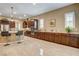 Bright kitchen featuring stainless steel appliances, granite countertops, bar seating and beautiful cabinetry and lighting at 2425 Amatrice St, Henderson, NV 89044
