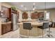 Kitchen with island, bar seating, and stainless-steel appliances at 2425 Amatrice St, Henderson, NV 89044