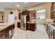 Spacious kitchen boasts granite countertops, stainless steel appliances, and ample storage in dark wood cabinets at 2425 Amatrice St, Henderson, NV 89044