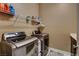 A clean and functional laundry room with modern stainless steel machines and storage shelves at 2425 Amatrice St, Henderson, NV 89044