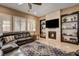 Cozy living space with fireplace, large windows, and comfortable seating at 2425 Amatrice St, Henderson, NV 89044