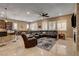 Open-concept living area with tile floors, stone fireplace, and modern furniture at 2425 Amatrice St, Henderson, NV 89044