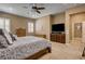 Comfortable main bedroom with ceiling fan, shutters, wood furniture, and neutral color palette at 2425 Amatrice St, Henderson, NV 89044