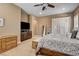 Main bedroom with a TV, plantation shutters, and soft carpet at 2425 Amatrice St, Henderson, NV 89044