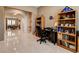 Open home office with modern desk, storage shelves, and bright tile flooring at 2425 Amatrice St, Henderson, NV 89044