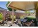 Covered patio with outdoor furniture and potted plants offers a cozy backyard retreat at 2425 Amatrice St, Henderson, NV 89044