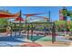 Colorful community playground with swings, shade structures, and various play equipment for children at 2425 Amatrice St, Henderson, NV 89044
