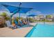 Inviting community pool area with lounge chairs and shade covers, perfect for relaxation and enjoyment under the sun at 2425 Amatrice St, Henderson, NV 89044