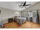 Comfortable bedroom with wood floors, vaulted ceilings, a ceiling fan, and windows with curtains at 2429 Sun Shores Dr, Las Vegas, NV 89128