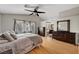 Comfortable bedroom with wood floors, vaulted ceilings, two dressers and an ensuite at 2429 Sun Shores Dr, Las Vegas, NV 89128