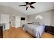 Comfortable bedroom with wood floors, vaulted ceilings, and a ceiling fan at 2429 Sun Shores Dr, Las Vegas, NV 89128