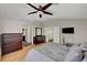 Comfortable bedroom with wood floors, vaulted ceilings, dressers and a ceiling fan at 2429 Sun Shores Dr, Las Vegas, NV 89128