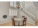 Inviting dining room featuring tile floors, neutral walls, and shutters. Staircase is visible at 2429 Sun Shores Dr, Las Vegas, NV 89128
