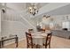 Inviting dining room featuring tile floors, neutral walls, with staircase and living room in view at 2429 Sun Shores Dr, Las Vegas, NV 89128