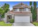 Charming two-story home featuring a terracotta roof, attached two-car garage, and low maintenance landscaping at 2429 Sun Shores Dr, Las Vegas, NV 89128