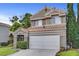 Charming two-story home featuring a terracotta roof, attached two-car garage, and low maintenance landscaping at 2429 Sun Shores Dr, Las Vegas, NV 89128