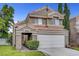 Charming two-story home featuring a terracotta roof, attached two-car garage, and low maintenance landscaping at 2429 Sun Shores Dr, Las Vegas, NV 89128