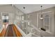 Bright hallway with a white railing staircase with overhead lighting and window with wooden shutters at 2429 Sun Shores Dr, Las Vegas, NV 89128