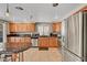 Bright kitchen with stainless appliances, granite countertops, wood cabinets, and tile flooring at 2429 Sun Shores Dr, Las Vegas, NV 89128