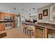 Open concept kitchen with a wine cooler, wood cabinets, granite counters, and stainless appliances at 2429 Sun Shores Dr, Las Vegas, NV 89128