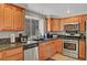 Well-appointed kitchen with stainless steel appliances, granite counters, and wooden cabinets at 2429 Sun Shores Dr, Las Vegas, NV 89128