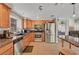 Well-lit kitchen with granite countertops, tile floors, wood cabinets, and stainless steel appliances at 2429 Sun Shores Dr, Las Vegas, NV 89128