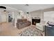 Open living room with a cozy fireplace, neutral decor, and tile flooring throughout the space at 2429 Sun Shores Dr, Las Vegas, NV 89128