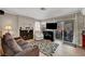Inviting living room features a cozy fireplace and sliding doors to the outdoor patio at 2429 Sun Shores Dr, Las Vegas, NV 89128