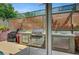Covered outdoor kitchen featuring a built-in grill, sink, and storage, perfect for outdoor cooking at 2429 Sun Shores Dr, Las Vegas, NV 89128
