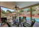 Inviting covered patio with ceiling fan, overlooks a sparkling pool and lush landscaping at 2429 Sun Shores Dr, Las Vegas, NV 89128