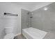Cozy bathroom with tub and shower combo featuring gray and white tile and modern gray flooring at 2451 N Rainbow Blvd # 2144, Las Vegas, NV 89108