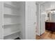 White closet with shelving and view to bathroom featuring granite countertop at 2451 N Rainbow Blvd # 2144, Las Vegas, NV 89108