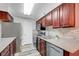 Well-lit kitchen features stainless steel appliances, granite countertops, and wood cabinets at 2451 N Rainbow Blvd # 2144, Las Vegas, NV 89108