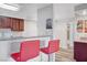 Kitchenette includes breakfast bar with red bar stools, wood cabinets, and granite counters at 2451 N Rainbow Blvd # 2144, Las Vegas, NV 89108